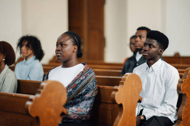 Diverse young adults in a church, listening to a sermon, embody spirituality, faith, and community in a modern setting. Peaceful atmosphere, traditional architecture enhances togetherness and hope